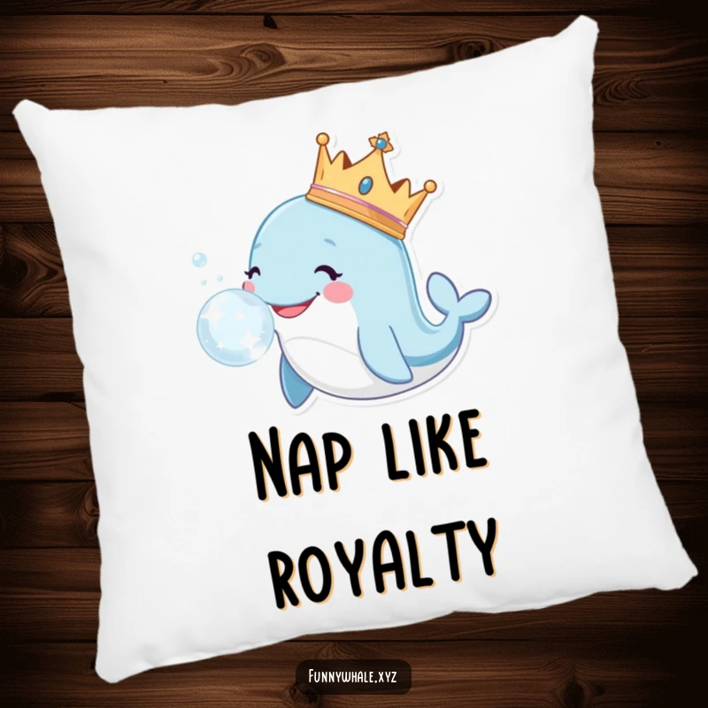 Smiling whale wearing a crown blows a large, sparkly bubble, featured on a comfortable and decorative pillow.